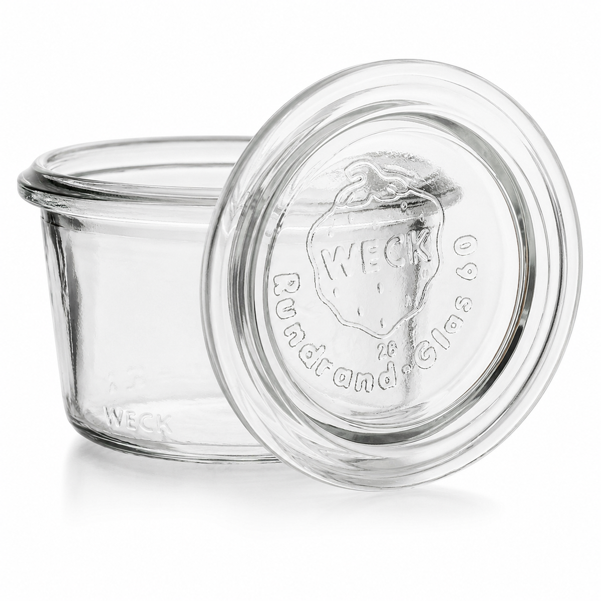 WECK-Mini-Sturzglas 80 ml RR60 aus Klarglas mit passendem Glasdeckel, Rundrandmündung und sichtbarer WECK-Prägung auf weißem Hintergrund.